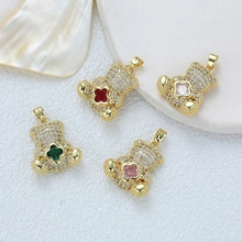 Close-up of 18K gold-plated bear pendants with colorful crystals and clover design