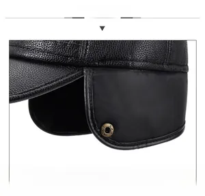 Detail of leather winter hat featuring ear flaps and textured lychee pattern finish