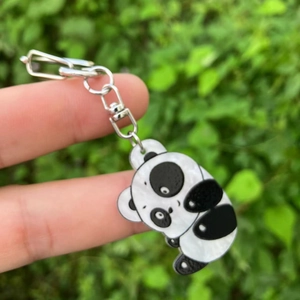 Cute cartoon panda keychain made of acrylic with embossed printing on a metal ring