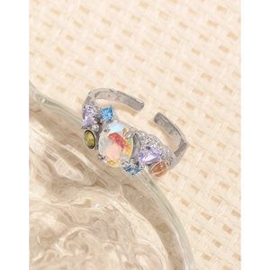 Adjustable S925 silver ring with colorful zircons and opal stone on glass surface