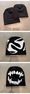 Detailed views of black knit beanies with abstract white patterns and plain minimalist design
