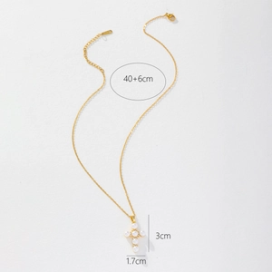Detail showing pearl-inlaid gold cross pendant with dimensions 3cm by 1.7cm on white background