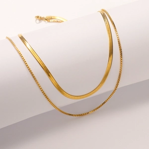 Close-up of double-layered 18K gold plated box and snake chain necklace texture