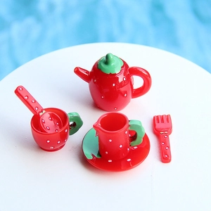 Detailed view of miniature 5-piece strawberry resin teapot set for dollhouse decor