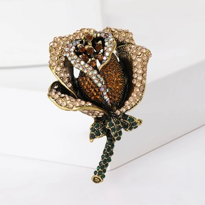 Close-up of elegant rose brooch with colorful rhinestones on a gold metal base