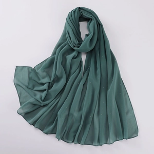 Detail shot of deep green pearl chiffon shawl with sparkling rhinestones texture