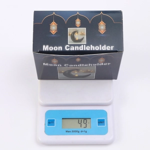 Star and moon candle holder in packaging weighed at 49g on digital scale
