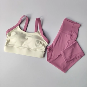 Two-piece yoga set with racerback bra and high-waisted leggings featuring side pockets