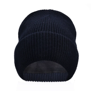Close-up of winter knitted beanie with double-layer wool lining and ribbed texture