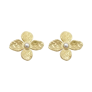 French vintage gold flower stud earrings with pearl centers on a white background