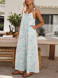 Detailed close-up of mint floral wide-leg jumpsuit with lace trim and side pockets