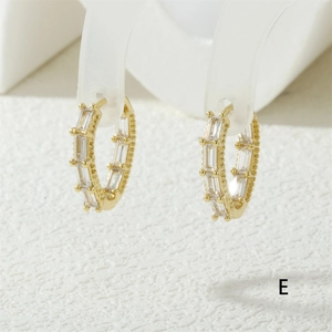 Detailed close-up of 18K gold plated hoop earrings with rectangular clear cubic zirconia