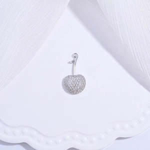 Macro shot of silver cherry pendant encrusted with sparkling cubic zirconia crystals