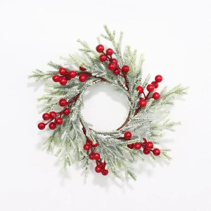 Frosted pine needle Christmas candle ring with red berries on white background