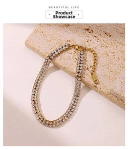 Close-up of double-row zircon bracelet with gold finish and S.STEEL engraved tag