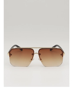 Macro detail of brown gradient lenses and gold metal bridge on aviator sunglasses