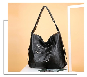 Detail view of black soft PU leather multi-pocket crossbody bag with adjustable straps