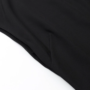 Detailed close-up of side seam pocket and plain weave fabric texture on black dress