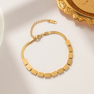 Gold titanium steel Love bracelet featuring flat snake chain and square engraved charms