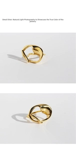 Detailed shot of abstract golden twisted liquid metal ring with flowing irregular lines