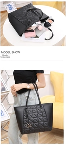 Detail showing spacious black quilted leather tote with elegant metal ring pendant charm