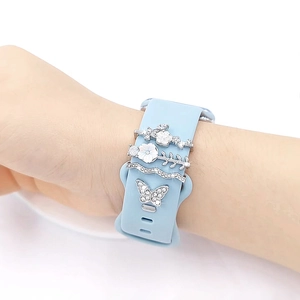 Blue silicone strap for Apple Watch featuring floral and butterfly metal diamond charms