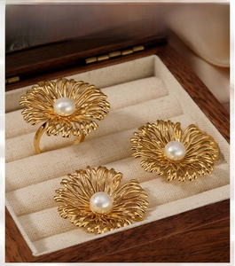Detailed macro of vintage daisy jewelry set with pearls in a wooden velvet box