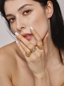 Detail of three luxury hollow gold rings with micro-inlaid zircon crystals on fingers