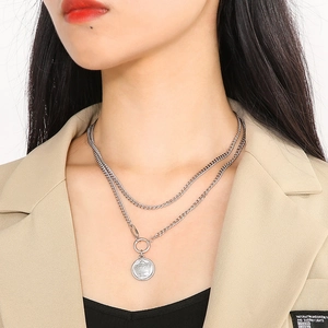 Close-up of double layer silver crown pendant necklace worn on model for retro style