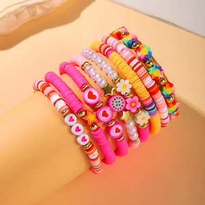 Rainbow beaded bracelet set with hearts and flowers on a display stand for women