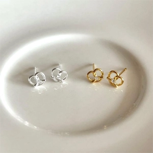 Minimalist twisted knot stud earrings in gold and silver finish with white zircon accents
