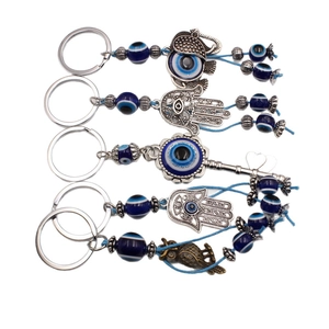Hamsa hand and evil eye charm keychains in silver plating with blue woven rope