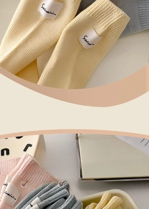 Close-up of ribbed combed cotton socks in pastel colors with brand label detail