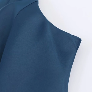 Detail of dark blue quick-dry athletic fabric showing professional stitching and texture