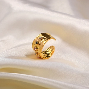 Hammered 18K gold plated wide ring with colorful gemstones on white silk background