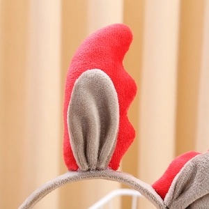 Close-up of plush reindeer ear headband in red and beige soft faux fur fabric