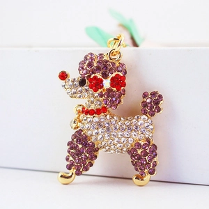Creative poodle keychain with purple and white crystals on a gold metal base
