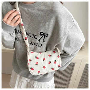 Detail of strawberry print corduroy crossbody bag showing texture and print pattern