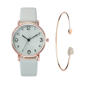 Detailed close-up of rose gold watch set with crystal-inlaid heart-shaped open bracelet