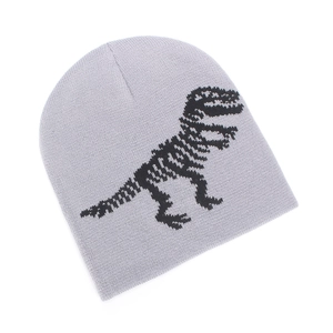 Detail of grey knitted winter hat featuring a black dinosaur skeleton jacquard pattern