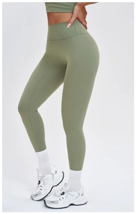 Detail view of olive green high-waisted yoga pants with wide waistband and matte texture