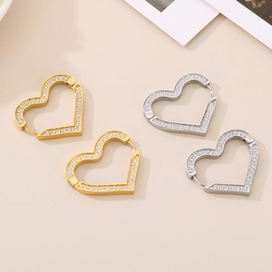 Detail of heart-shaped hoop earrings in gold and silver with micro-pave cubic zirconia
