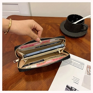 Detailed interior of a black leather long wallet showing multi-card slots and phone storage