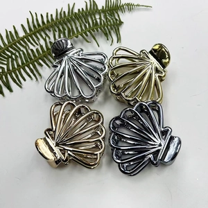 Fan-shaped metal hair claws in gold, silver, rose gold, and black on white background