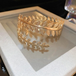 Elegant gold leaf spiral open bangle and arm cuff bracelet with a minimalist design