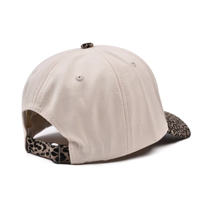 Beige five-panel cap with leopard print brim and adjustable back strap on white background