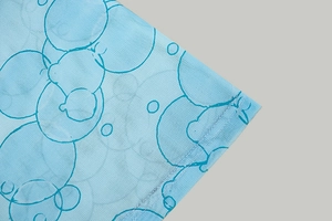 Detailed macro view of blue mesh fabric with circular geometric printed patterns