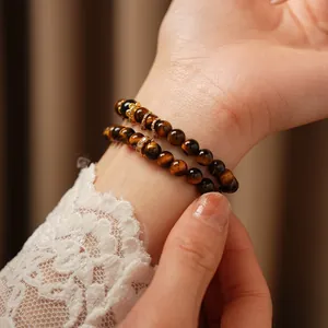 Macro shot of tiger eye stone bracelet with golden engraved beads and silk luster