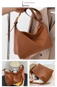 Detail of a brown leather tote bag with a golden adjustable buckle strap and zipper closure