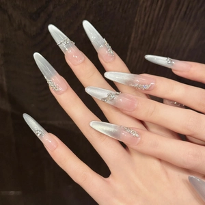 Blue cat eye press-on nails with silver glitter gradient and rhinestone accents